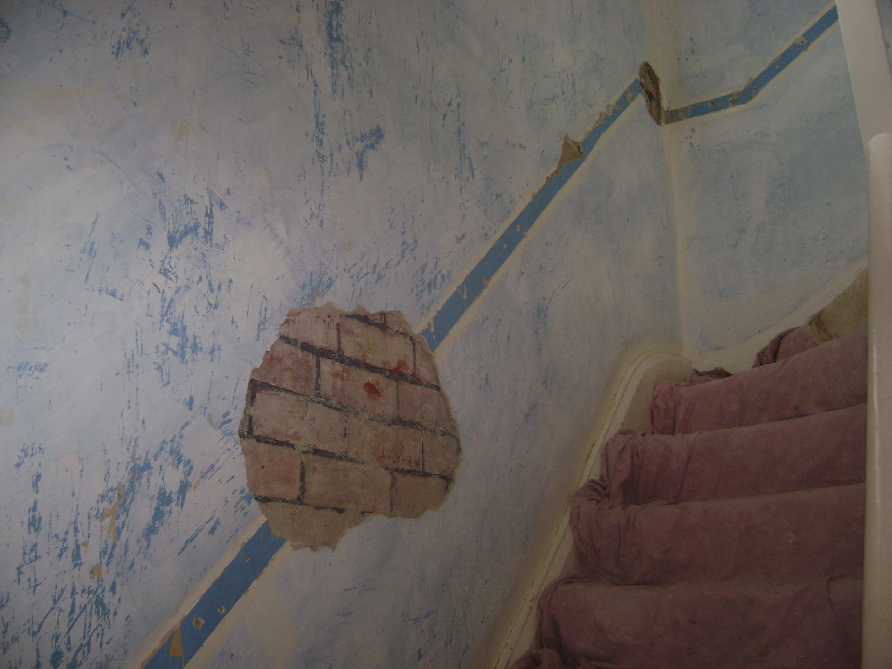 After the customer removed dado rail from this stairwell, a few sections of the wall were blown