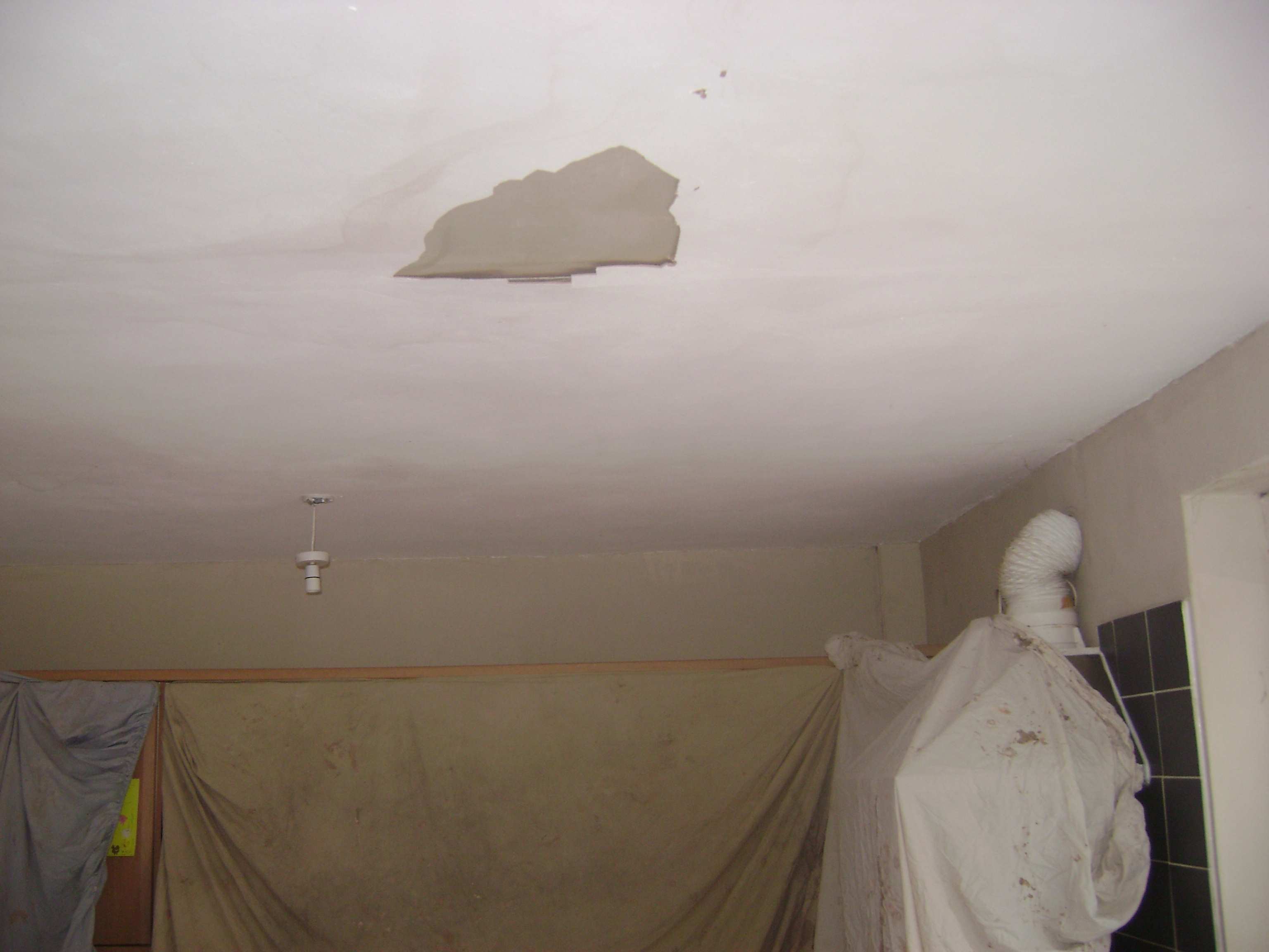 This ceiling had been water damaged from a leaking pipe above and allowed to dry, causing the plaster to blow